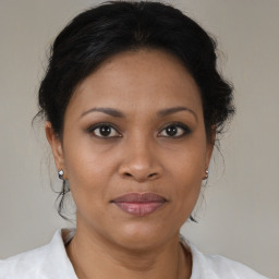 Joyful black adult female with medium  brown hair and brown eyes