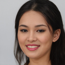 Joyful asian young-adult female with long  brown hair and brown eyes