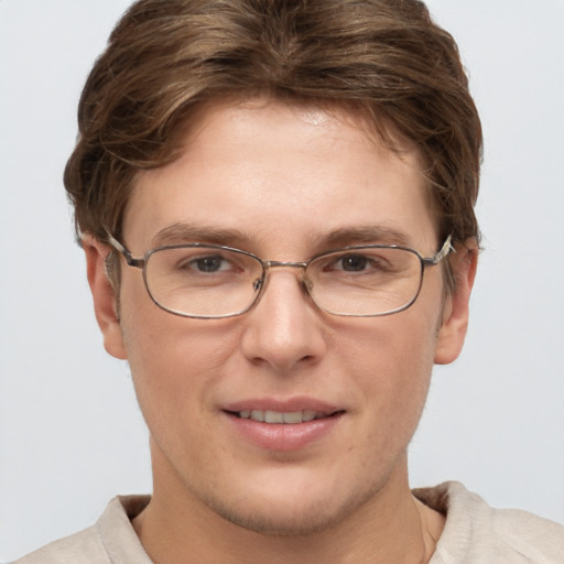 Joyful white adult male with short  brown hair and grey eyes