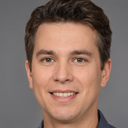 Joyful white adult male with short  brown hair and brown eyes