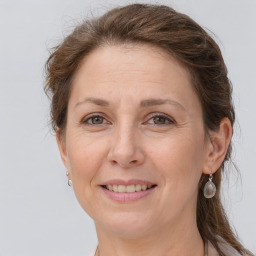 Joyful white adult female with long  brown hair and grey eyes