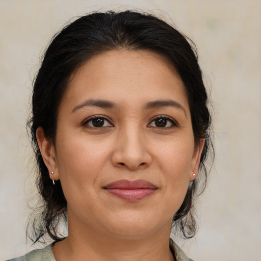 Joyful latino young-adult female with medium  brown hair and brown eyes