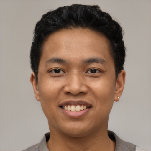 Joyful asian young-adult male with short  black hair and brown eyes