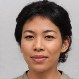 Joyful asian young-adult female with medium  brown hair and brown eyes