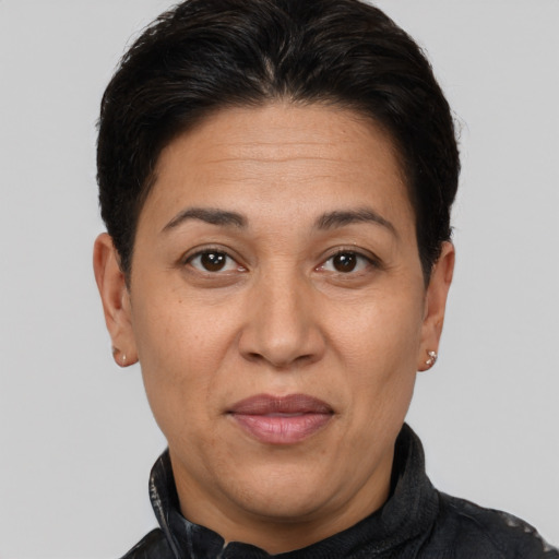 Joyful latino adult female with short  brown hair and brown eyes