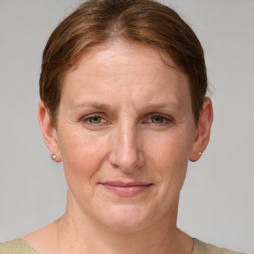 Joyful white adult female with short  brown hair and blue eyes