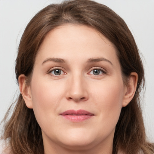 Joyful white young-adult female with long  brown hair and grey eyes