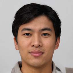 Joyful asian young-adult male with short  black hair and brown eyes