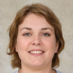 Joyful white adult female with medium  brown hair and grey eyes