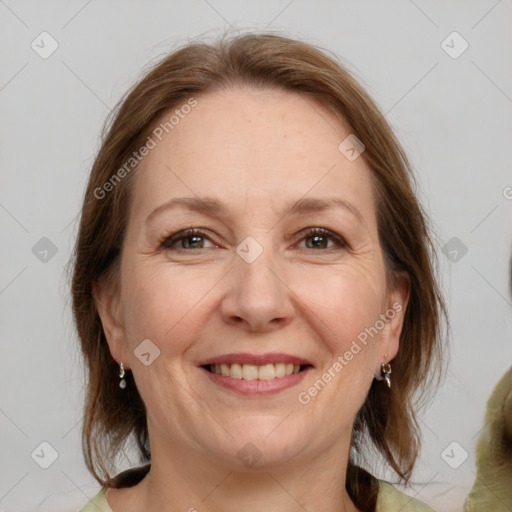 Joyful white adult female with medium  brown hair and grey eyes