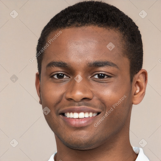 Joyful black young-adult male with short  brown hair and brown eyes