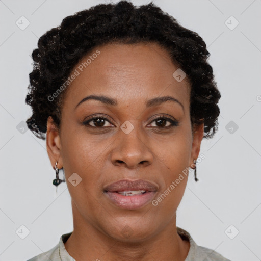 Joyful black adult female with short  brown hair and brown eyes