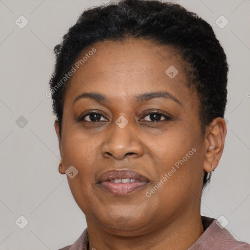 Joyful black adult female with short  brown hair and brown eyes