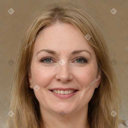 Joyful white adult female with long  brown hair and brown eyes