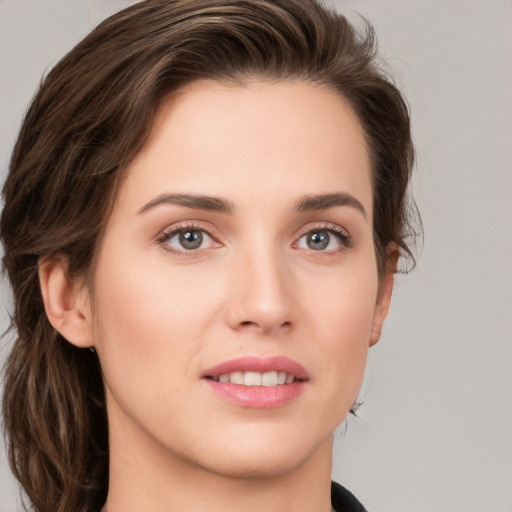 Joyful white young-adult female with medium  brown hair and grey eyes