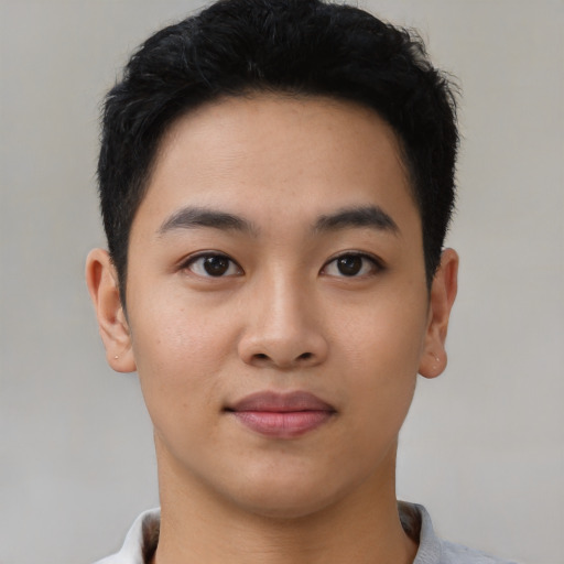 Joyful asian young-adult male with short  black hair and brown eyes