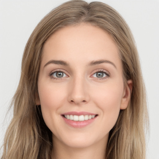 Joyful white young-adult female with long  brown hair and green eyes