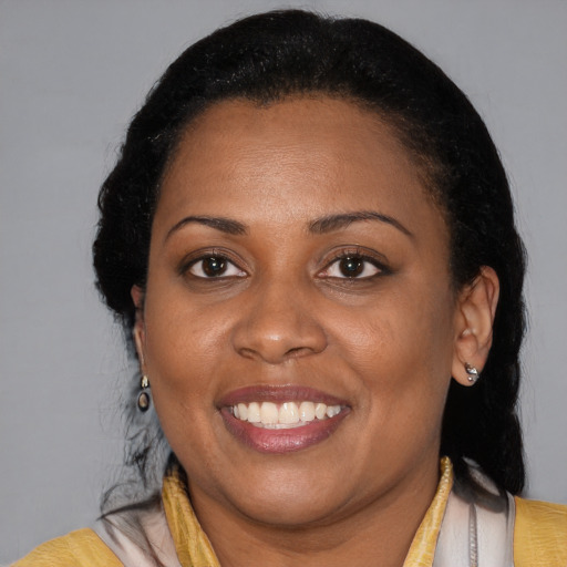 Joyful latino young-adult female with medium  black hair and brown eyes