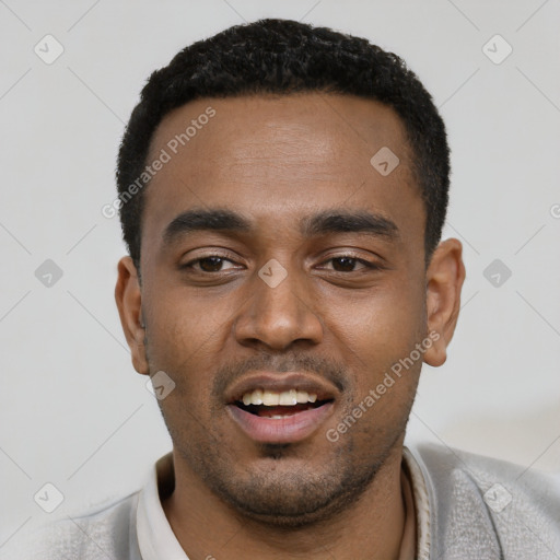 Joyful black young-adult male with short  black hair and brown eyes