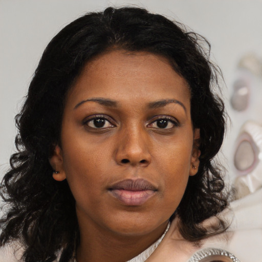 Neutral black young-adult female with medium  brown hair and brown eyes
