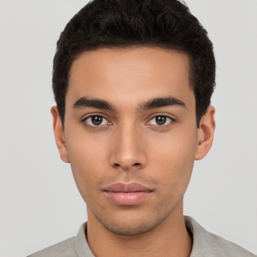 Neutral latino young-adult male with short  brown hair and brown eyes