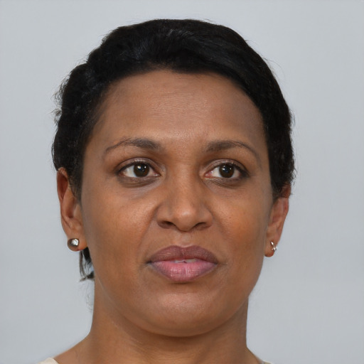 Joyful black adult female with short  brown hair and brown eyes