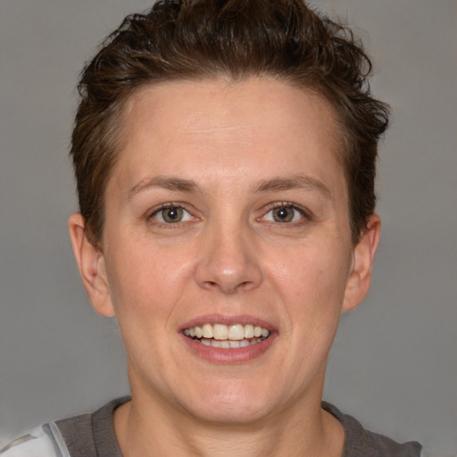 Joyful white adult female with short  brown hair and grey eyes