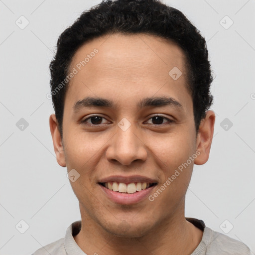 Joyful latino young-adult male with short  brown hair and brown eyes