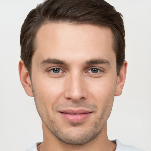 Joyful white young-adult male with short  brown hair and brown eyes