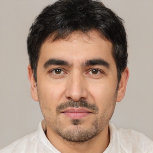 Joyful white young-adult male with short  black hair and brown eyes