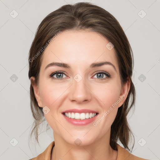 Joyful white young-adult female with medium  brown hair and grey eyes