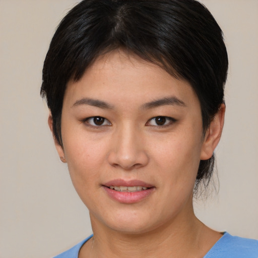 Joyful asian young-adult female with short  brown hair and brown eyes
