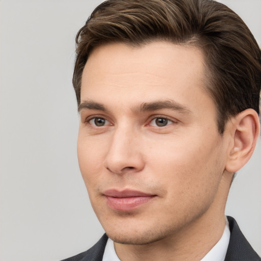 Joyful white young-adult male with short  brown hair and brown eyes