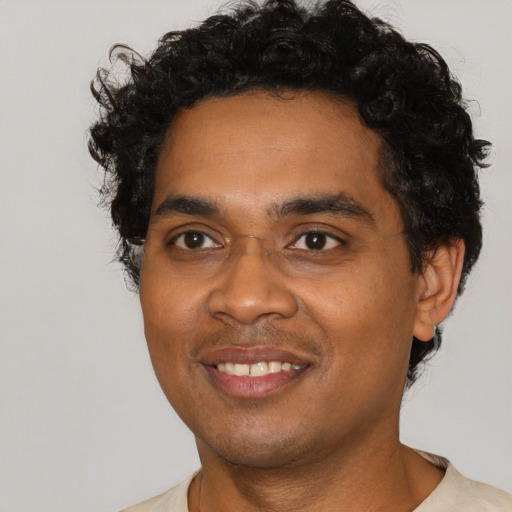 Joyful black young-adult male with short  black hair and brown eyes