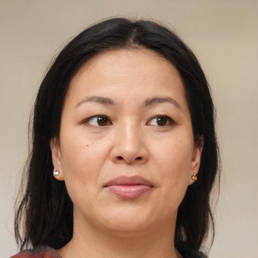 Joyful asian adult female with medium  brown hair and brown eyes