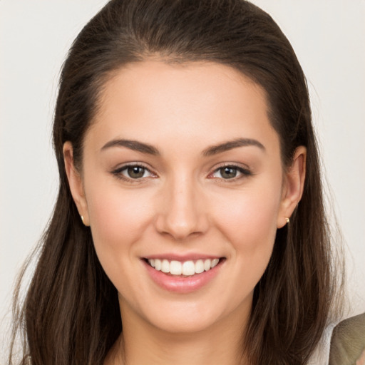 Joyful white young-adult female with long  brown hair and brown eyes