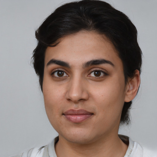 Joyful latino young-adult female with short  brown hair and brown eyes