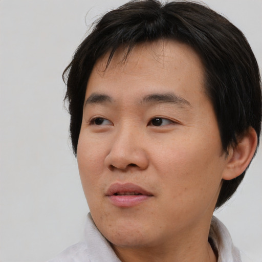 Neutral asian young-adult male with short  brown hair and brown eyes