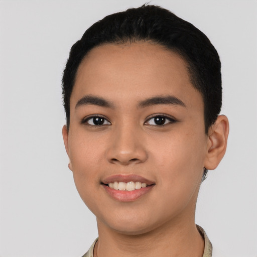 Joyful latino young-adult female with short  black hair and brown eyes