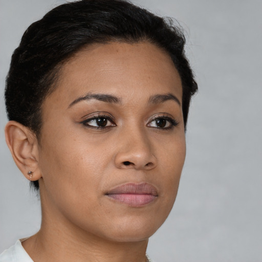 Joyful latino young-adult female with short  brown hair and brown eyes