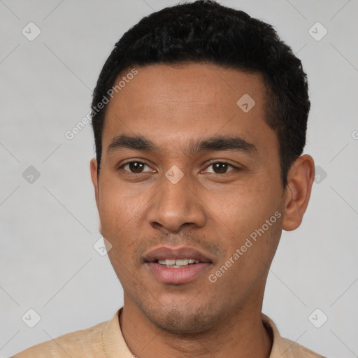 Joyful latino young-adult male with short  black hair and brown eyes