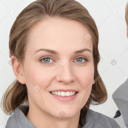 Joyful white young-adult female with medium  brown hair and blue eyes