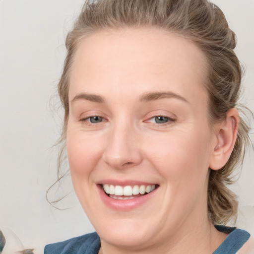 Joyful white young-adult female with medium  brown hair and blue eyes