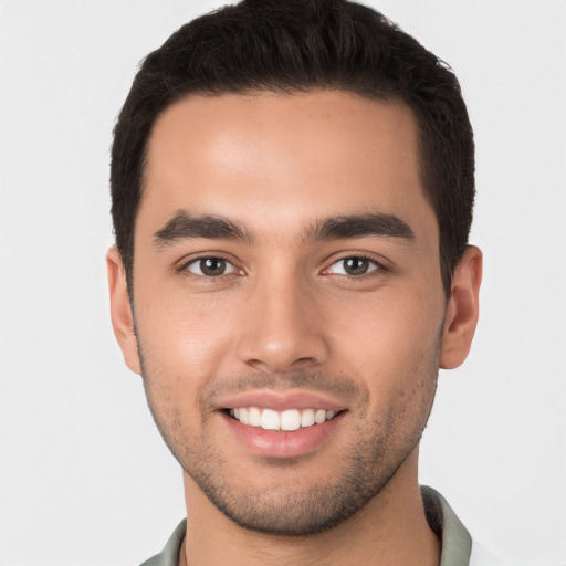 Joyful white young-adult male with short  brown hair and brown eyes