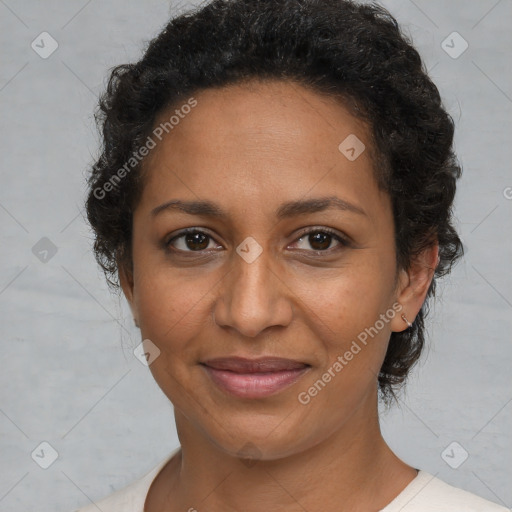 Joyful black adult female with short  brown hair and brown eyes