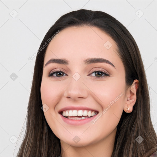 Joyful white young-adult female with long  black hair and brown eyes