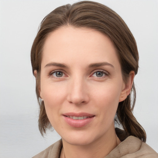 Joyful white young-adult female with medium  brown hair and grey eyes