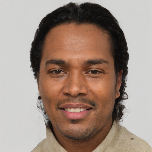 Joyful black young-adult male with short  black hair and brown eyes