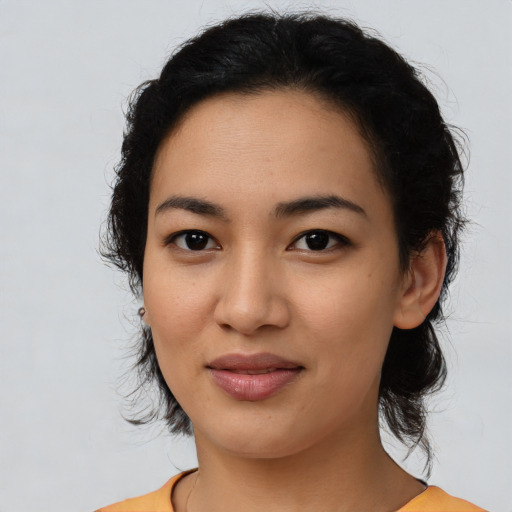 Joyful latino young-adult female with medium  black hair and brown eyes