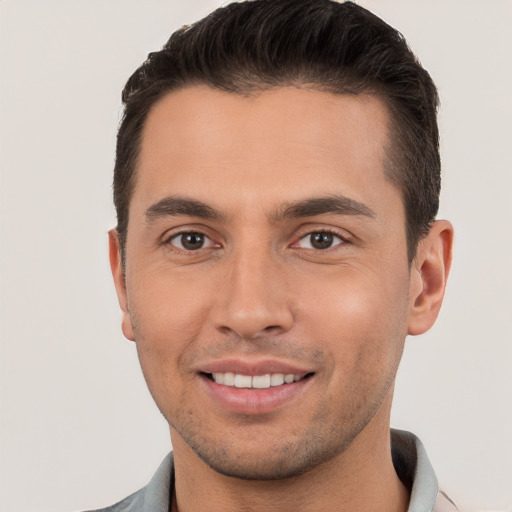 Joyful white young-adult male with short  brown hair and brown eyes